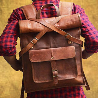 A brown leather vintage laptop bag is worn by a person