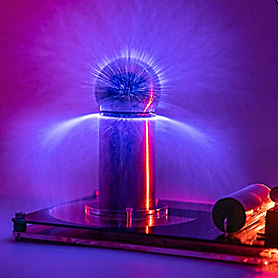 A table top tesla coil is displayed generating sparks and illuminating the room with purple pink lights.