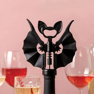 A wine bottle opener corkscrew in the shape of a bat is presented with its wings opened and its beer opener part shaped as a bat's head with ears popping on its sides.