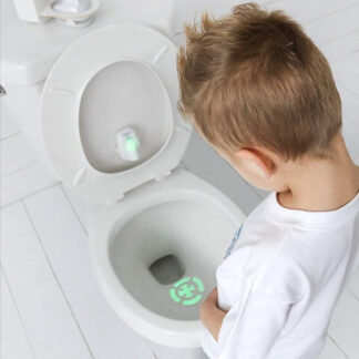 A toilet bowl bullseye is pointed onto a spot on the toilet bowl and a little kid is trying to pee on it.