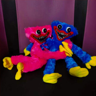 Two scary plush toys of characters from the video game "Poppy Play Time" are sitting on the sofa hugging each other.