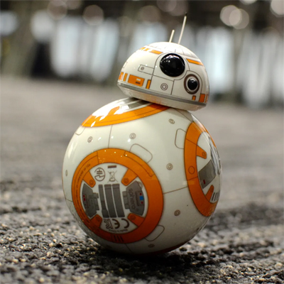 From Star Wars the BB 8 Droid is represented on a carpet standing on its own. Thhe model is orange and white color.