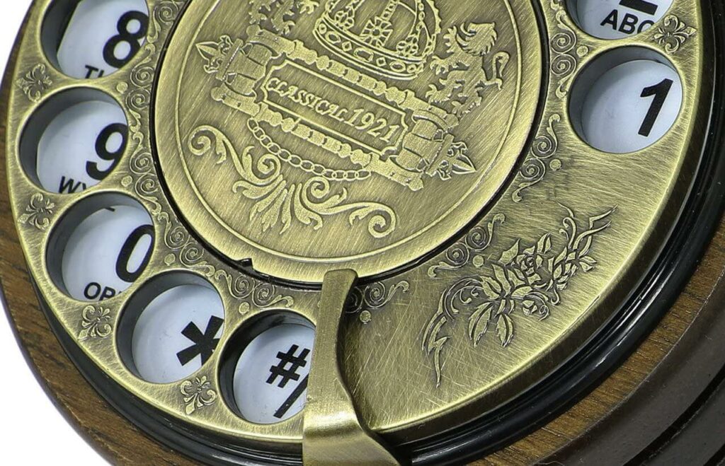 The rotary dial is displayed zoomed in and the brass-colored metallic engravings are visible.