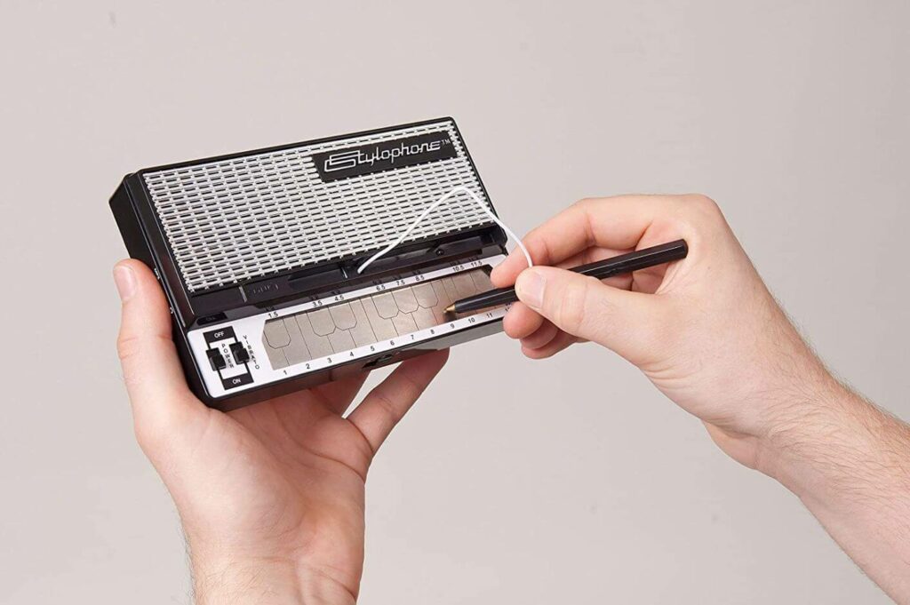 Stylophone is displayed being played with its stylus.